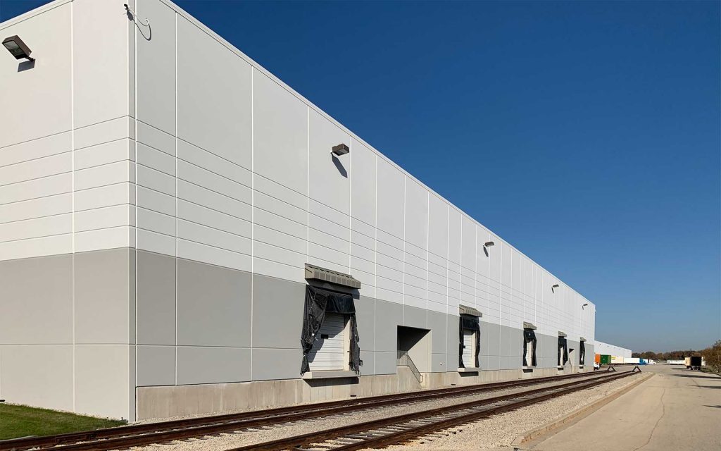 Industrial facility exterior being painted